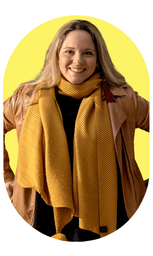 Happy woman wearing yellow with hands on her hips