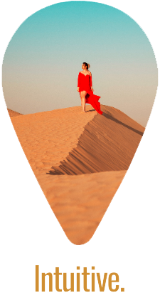 Woman in red dress walking down a sand dune with the world 'intuitive' typed below
