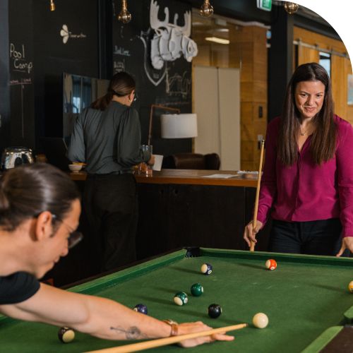 two people playing pool