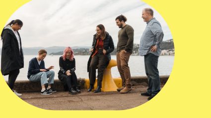 Tourwriter team on pier with a yellow background