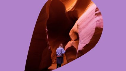 A traveller exploring a cavern with a purple background