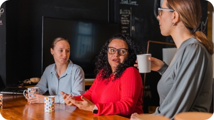 women sharing ideas over coffee