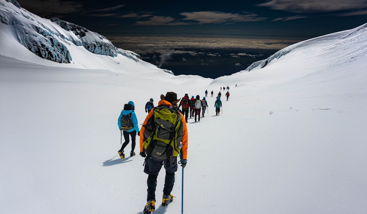 Hikers on Mount Ruapehu in Tongariro National Park, North Island, New Zealand, designed by Ahipara Luxury Travel