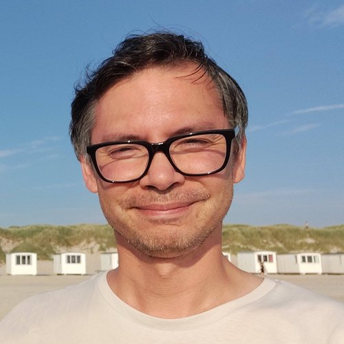 Christian Berger, founder of Nordic DMC Elan Norway, smiling on a Norwegian beach in summer sunshine