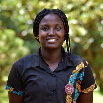 Linda Nabwire, Travel Consultant at ViaVia Adventures, smiling outdoors in Entebbe, Uganda